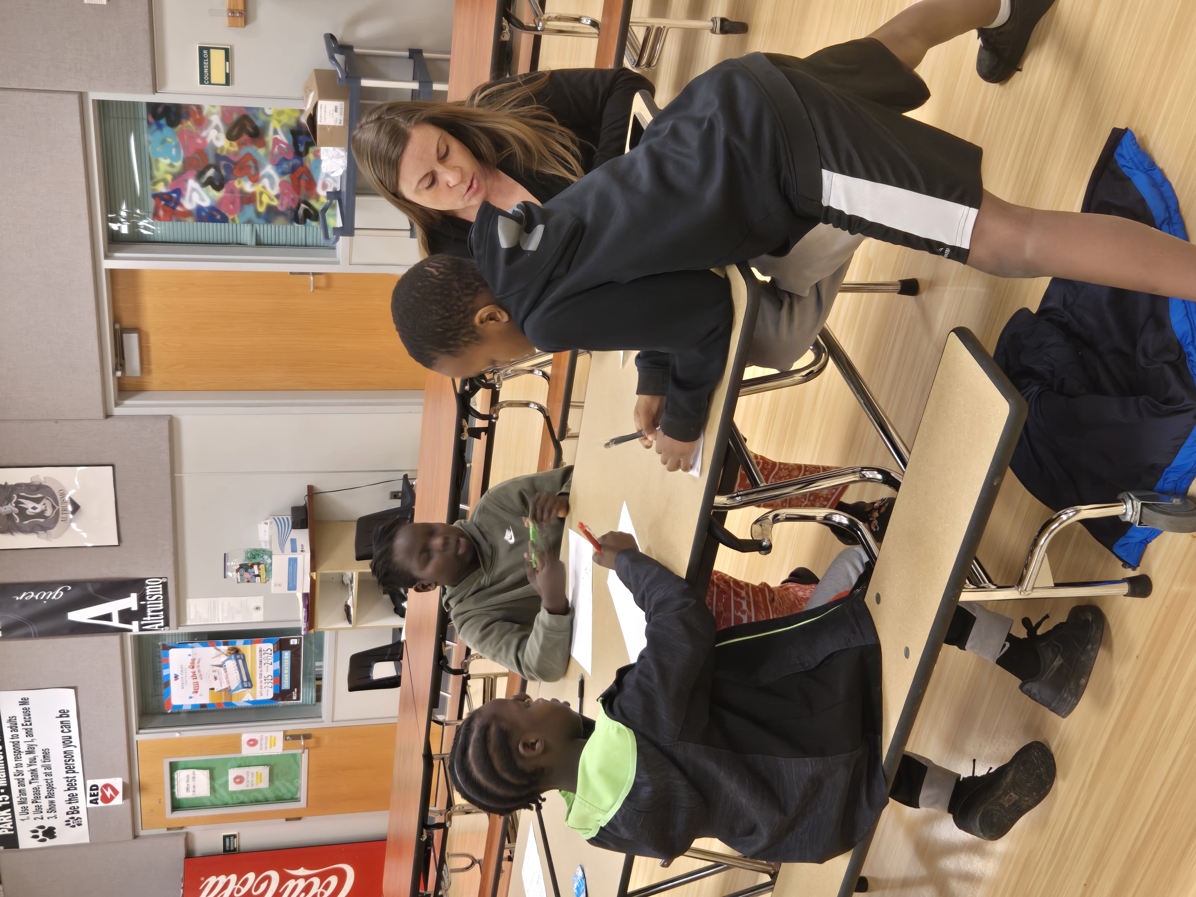 SDM volunteer smiling with students